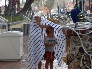Mattie and Ethan got caught in a rain shower coming back from the pool.  Matthew put his towel around Ethan.