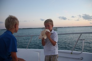Matthew blowing his conch.  James prefers not to try.