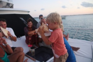 Ethan having a go at the conch.  We had supper at the boat Family Business who we met through Celebration.