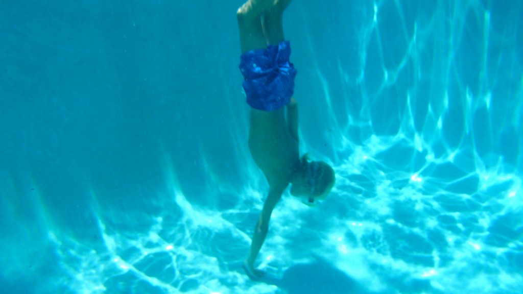 James swimming for the bottom of the deep end of the pool.