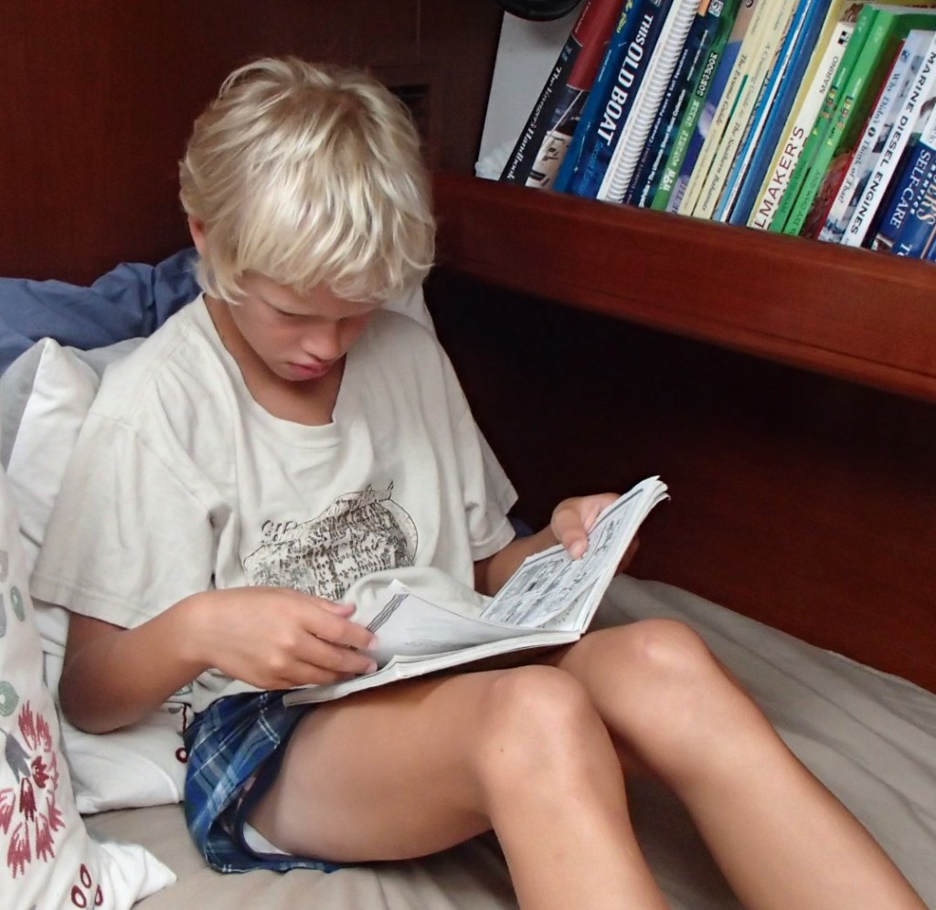 James' favorite thing to do, read quietly on Mom's bed.